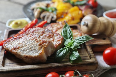 Photo of Delicious grilled meat and vegetables on table, closeup