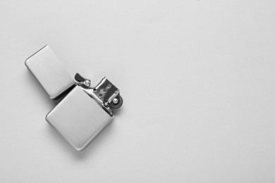 Photo of Gray metallic cigarette lighter on white background, top view. Space for text