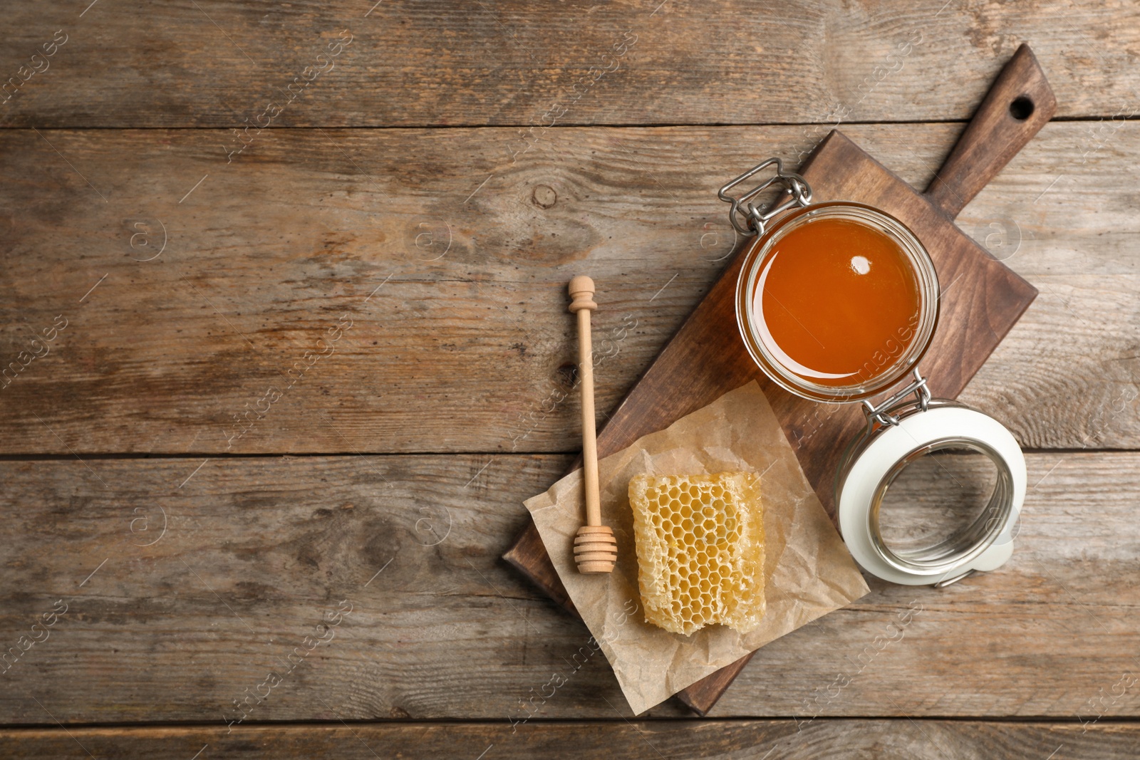 Photo of Flat lay composition with fresh honey on wooden background