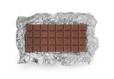 Delicious milk chocolate bar with foil isolated on white, top view