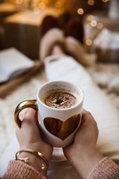 Photo of Woman with cup of cocoa indoors , closeup. Christmas mood