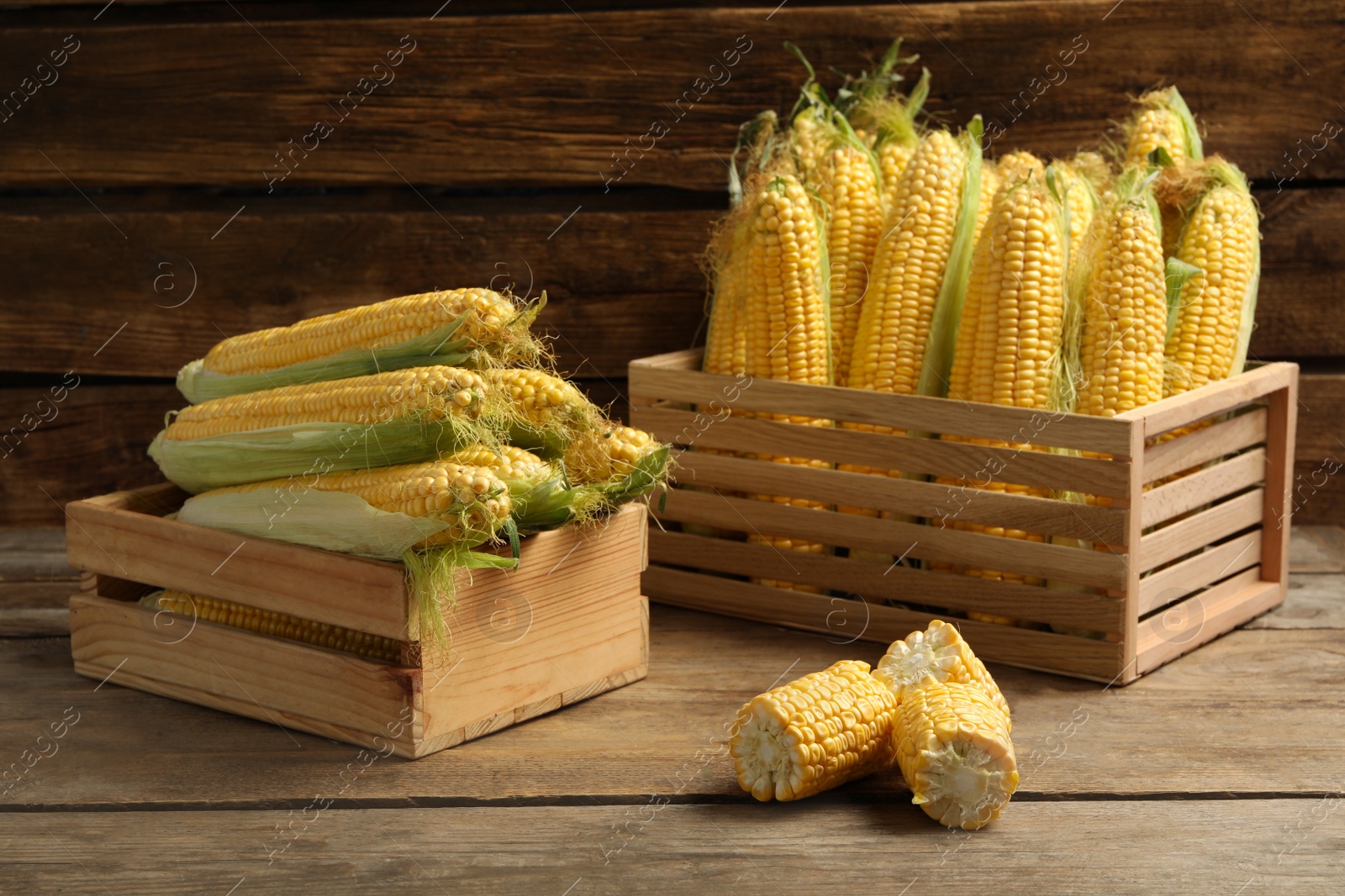 Photo of Tasty sweet corn cobs on wooden table