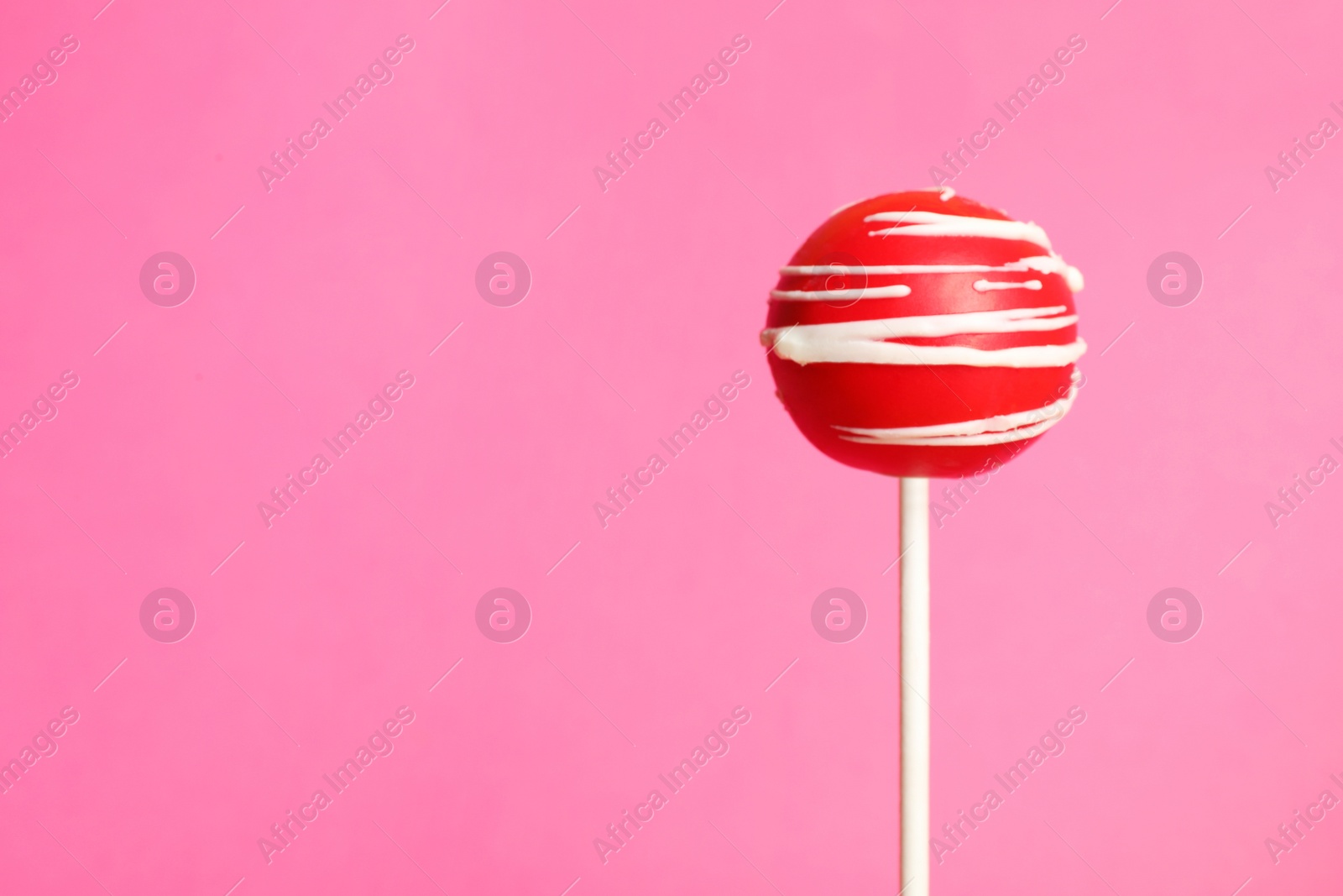 Photo of Bright delicious cake pop on color background. Space for text