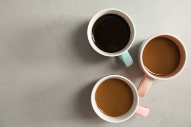 Photo of Flat lay composition with cups of coffee on gray background. Food photography