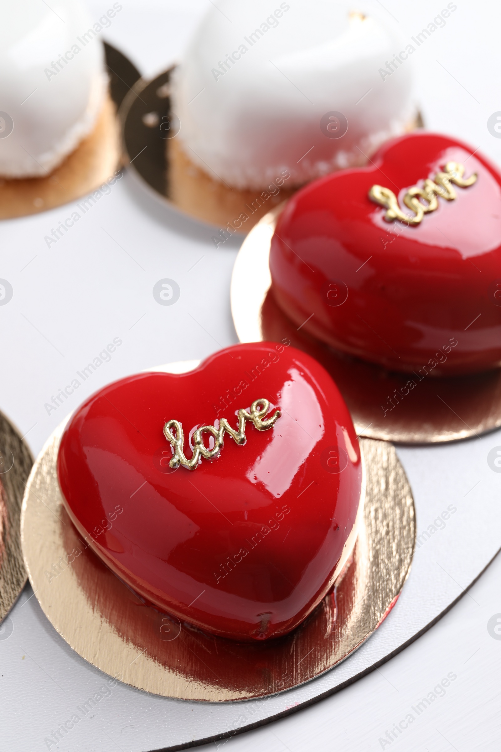 Photo of St. Valentine's Day. Delicious heart shaped cakes on white wooden table