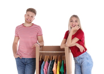 Young couple near wardrobe box on white background