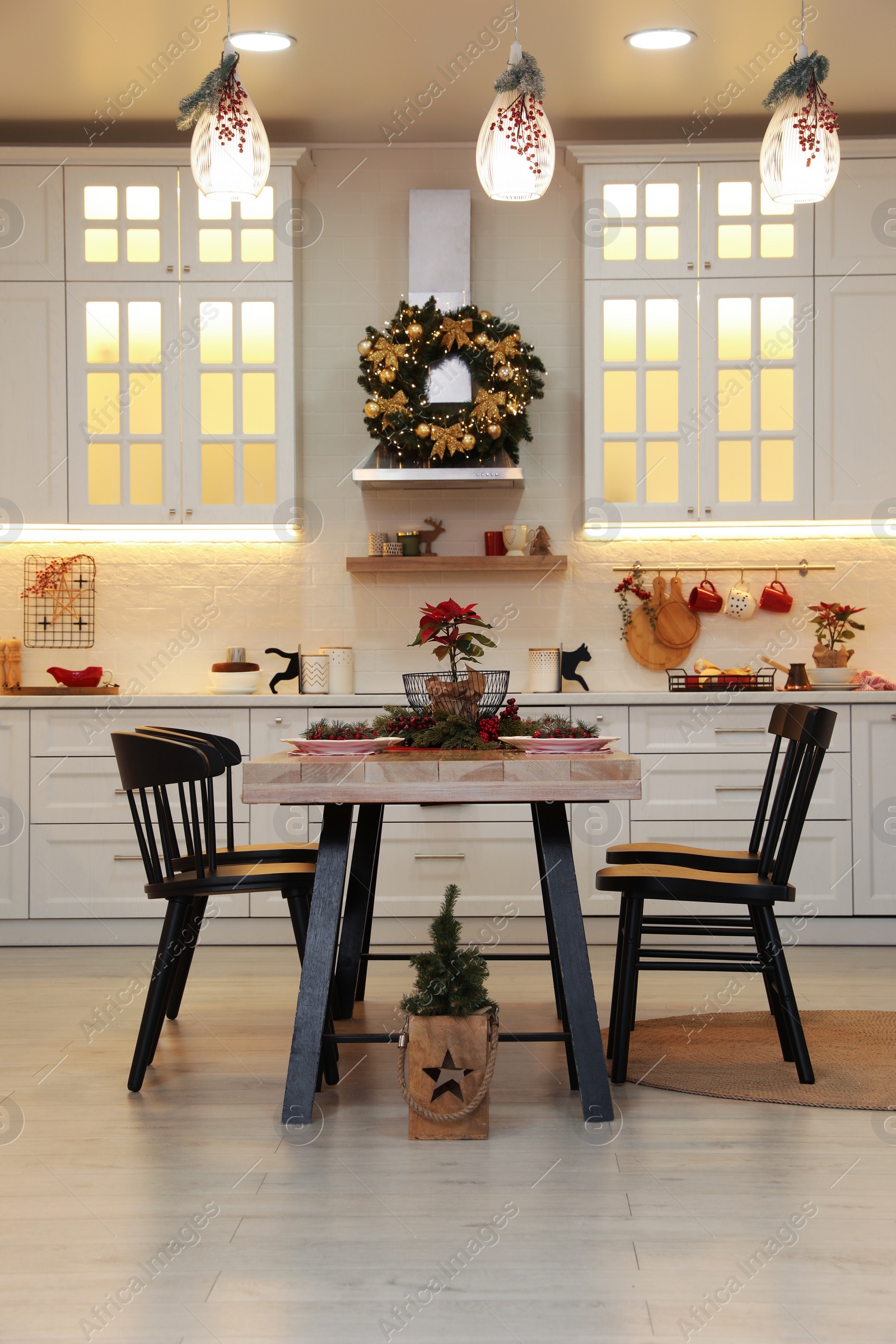 Photo of Cozy dining room interior with beautiful Christmas wreath and festive decor