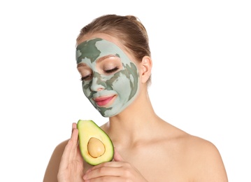 Photo of Beautiful woman holding avocado near her face with clay mask on white background