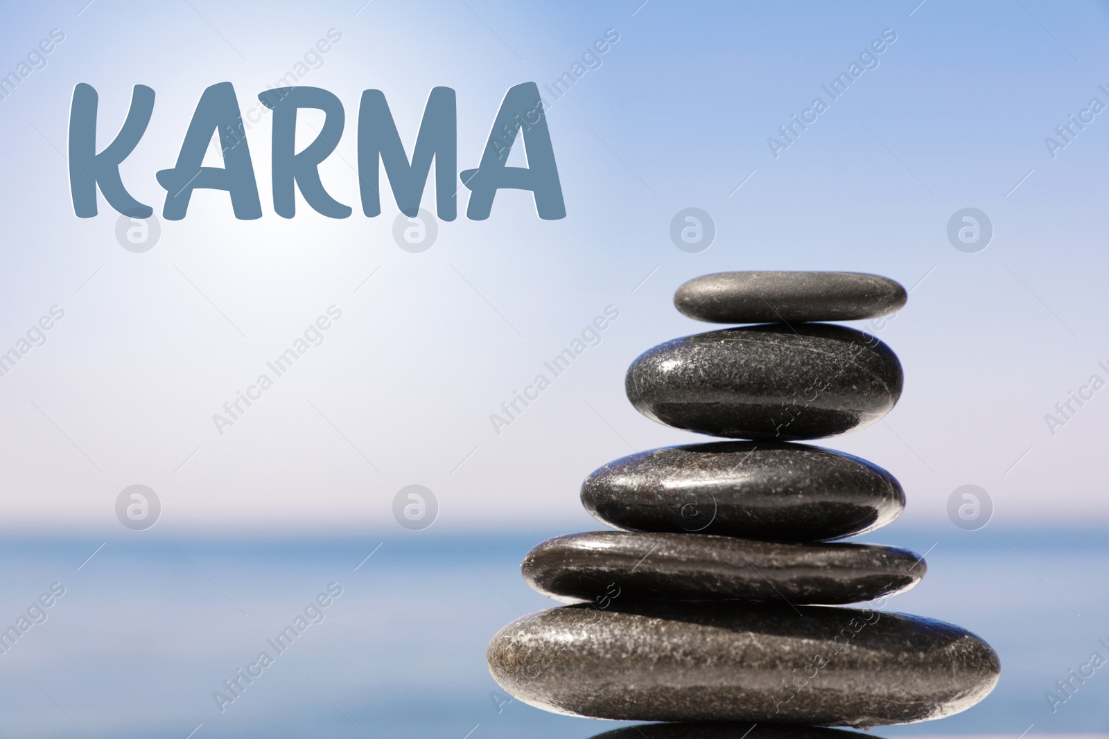 Image of Karma concept. Stack of stones near sea, closeup