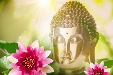 Beautiful golden Buddha sculpture and lotus flowers on color background