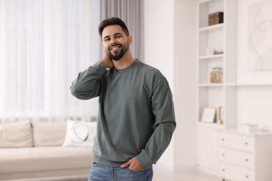 Happy man in stylish sweater at home