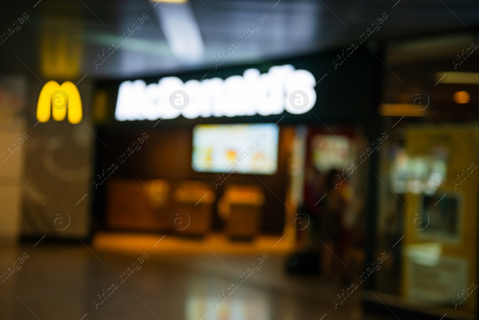 Photo of WARSAW, POLAND - AUGUST 05, 2022: Blurred view of McDonald's Restaurant entrance indoors