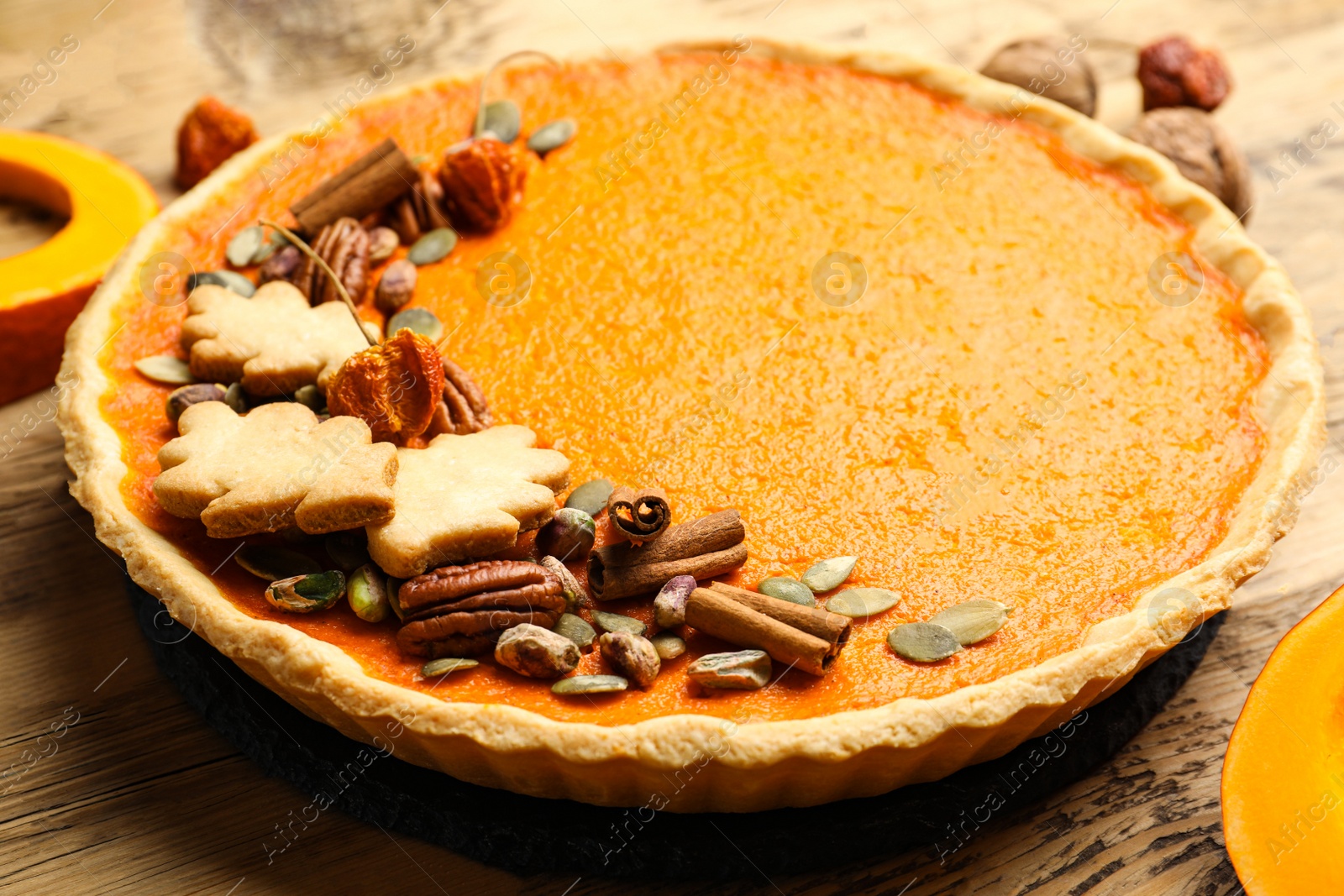 Photo of Delicious homemade pumpkin pie on wooden table, closeup