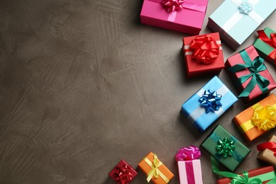 Photo of Many colorful gift boxes on grey table, flat lay. Space for text