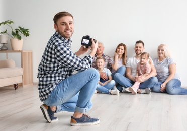 Professional photographer taking photo of family in studio