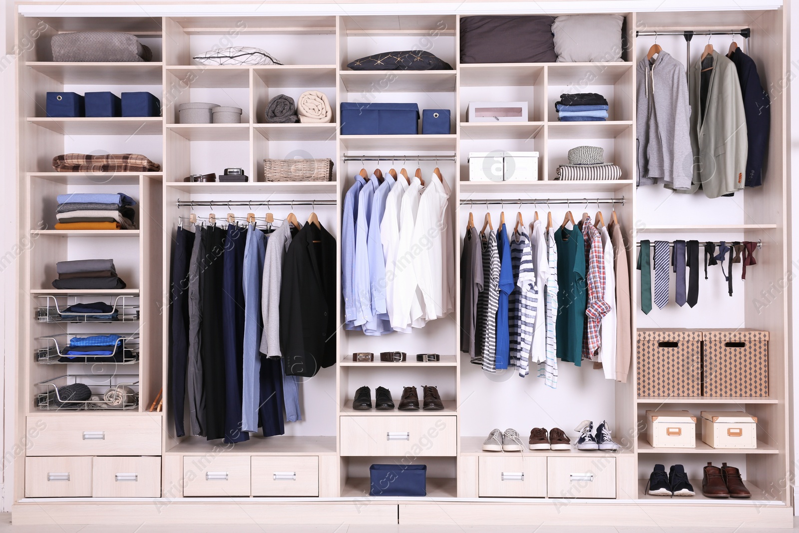 Photo of Large wardrobe with different clothes, home stuff and shoes