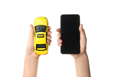 Woman with taxi car model and smartphone on white background, closeup. Space for design