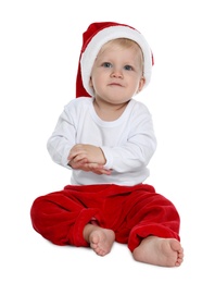 Photo of Cute baby in Santa hat and Christmas pajamas sitting on white background