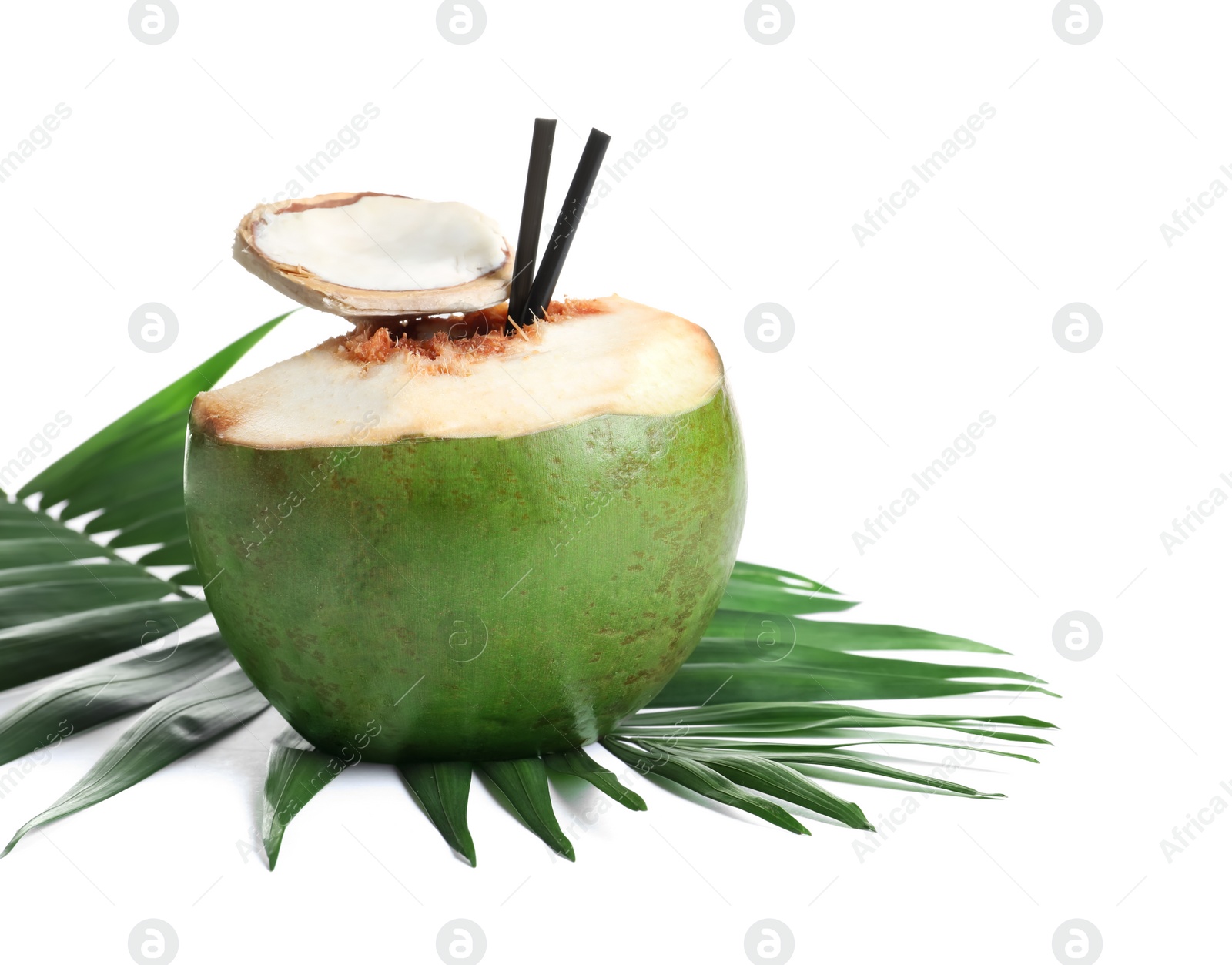 Photo of Fresh green coconut with drinking straws and palm leaf on white background