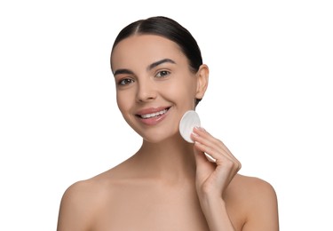 Beautiful woman removing makeup with cotton pad on white background