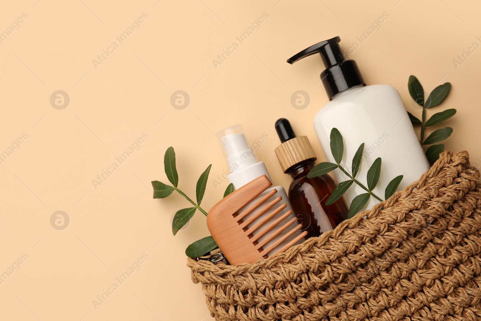 Photo of Preparation for spa. Compact toiletry bag with different cosmetic products on beige background, flat lay. Space for text