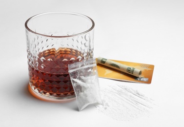 Photo of Composition with cocaine and glass of alcohol on white background