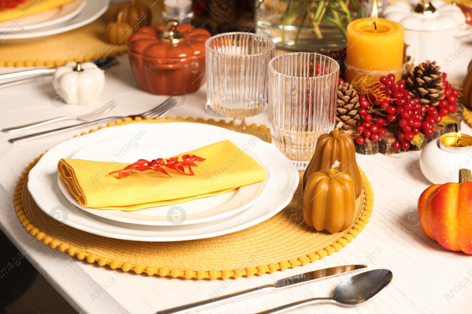 Photo of Autumn table setting with floral decor and pumpkins indoors