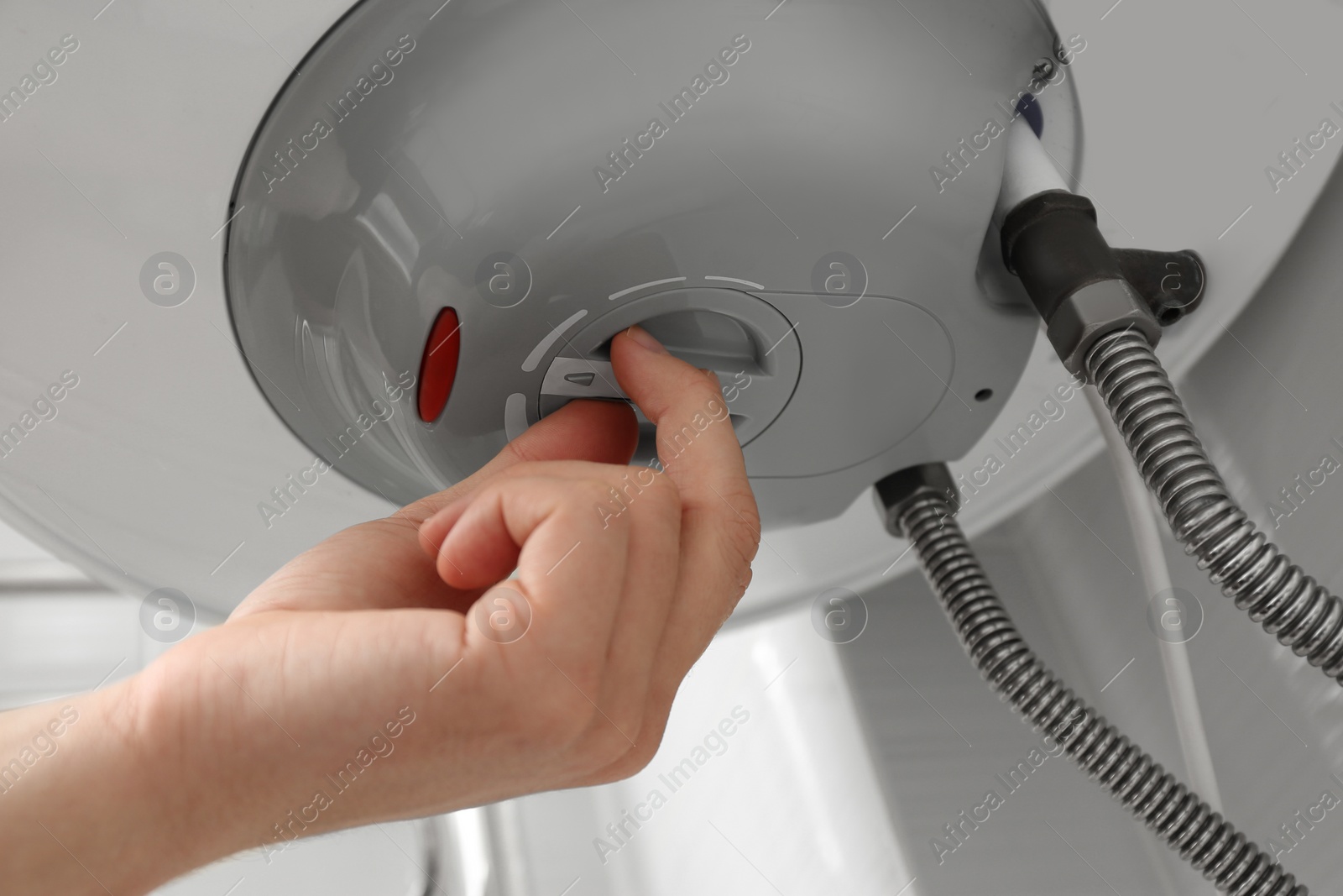 Photo of Woman adjusting maximum energy efficiency indicator indoors, closeup. Boiler installation