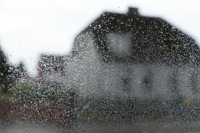 Blurred view of city street from window on rainy day