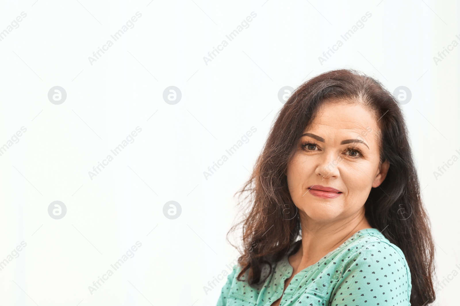 Photo of Portrait of beautiful older woman against light background with space for text