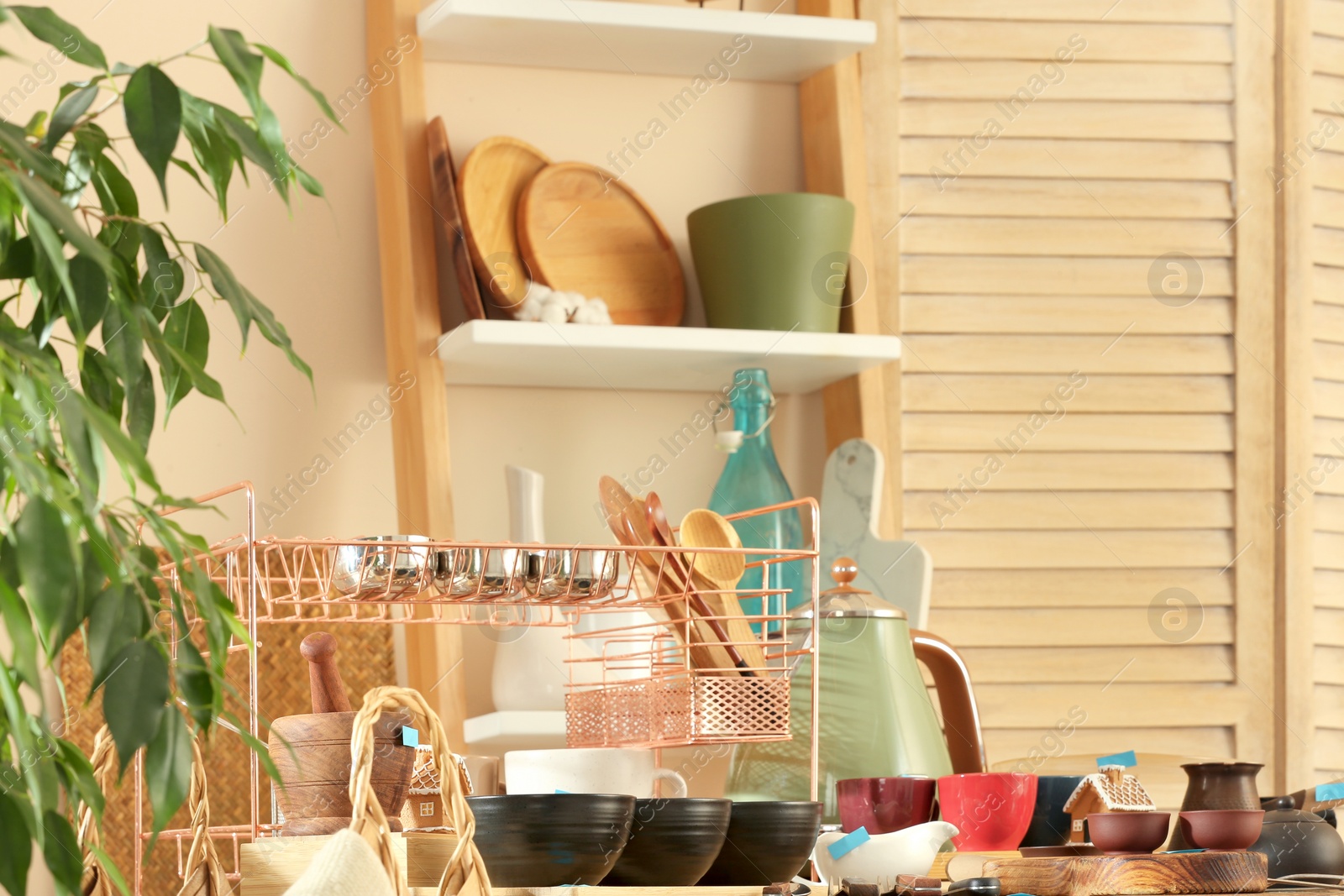 Photo of Many different cooking utensils in room. Garage sale