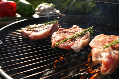 Photo of Cooking meat on barbecue grill outdoors, closeup