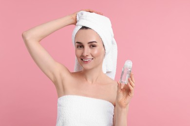 Photo of Beautiful woman with deodorant on pink background