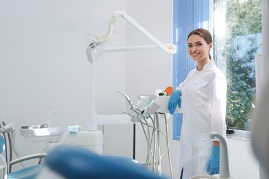 Portrait of professional dentist at workplace in clinic