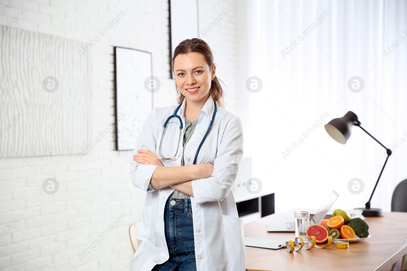 Photo of Nutritionist with stethoscope near desk in office