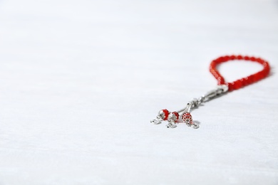 Photo of Muslim prayer beads and space for text on white background