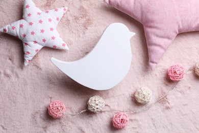 Photo of Flat lay composition with bird shaped child's night lamp on pink fabric