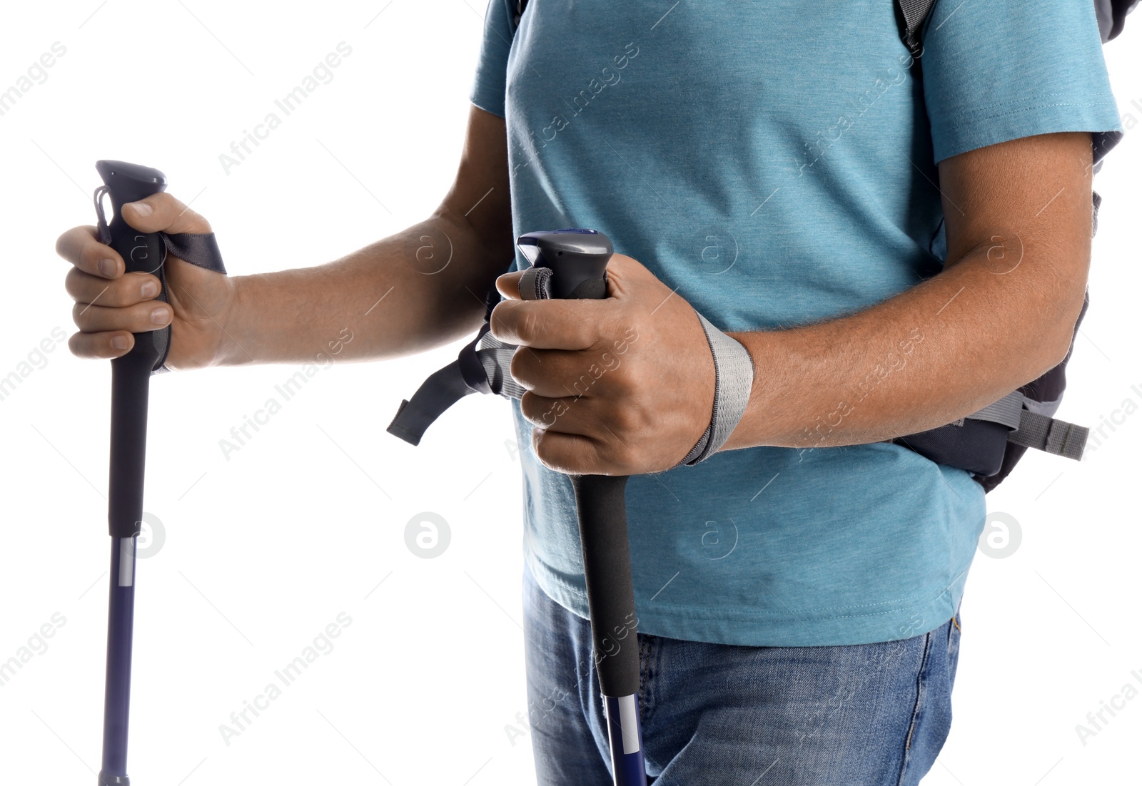 Photo of Male hiker with backpack and trekking poles on white background, closeup