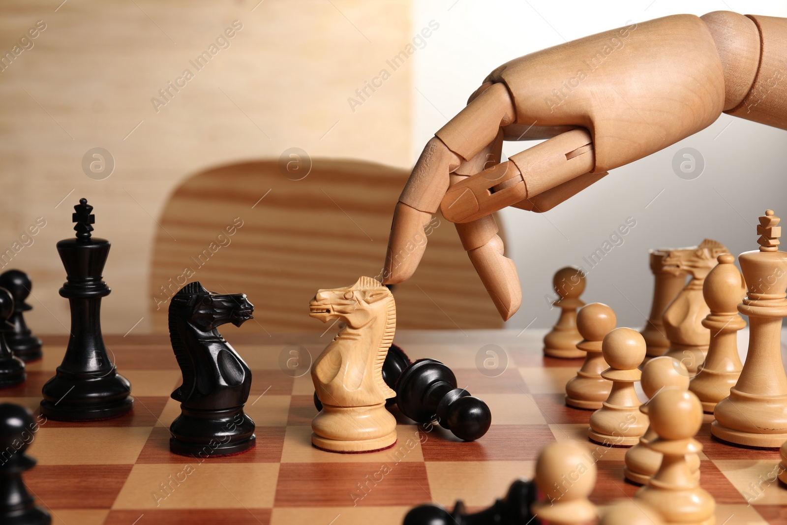 Photo of Robot moving chess piece on board, closeup. Wooden hand representing artificial intelligence