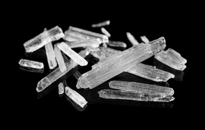 Photo of Menthol crystals on black background, closeup view