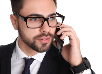 Photo of Young businessman talking on smartphone against white background, closeup