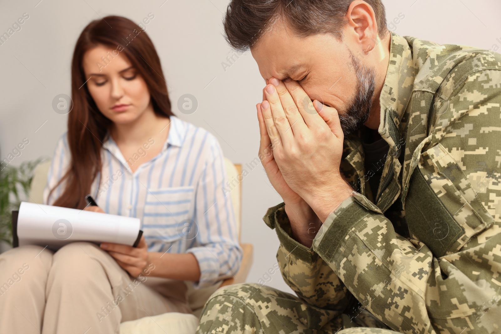 Photo of Psychologist working with military officer in office