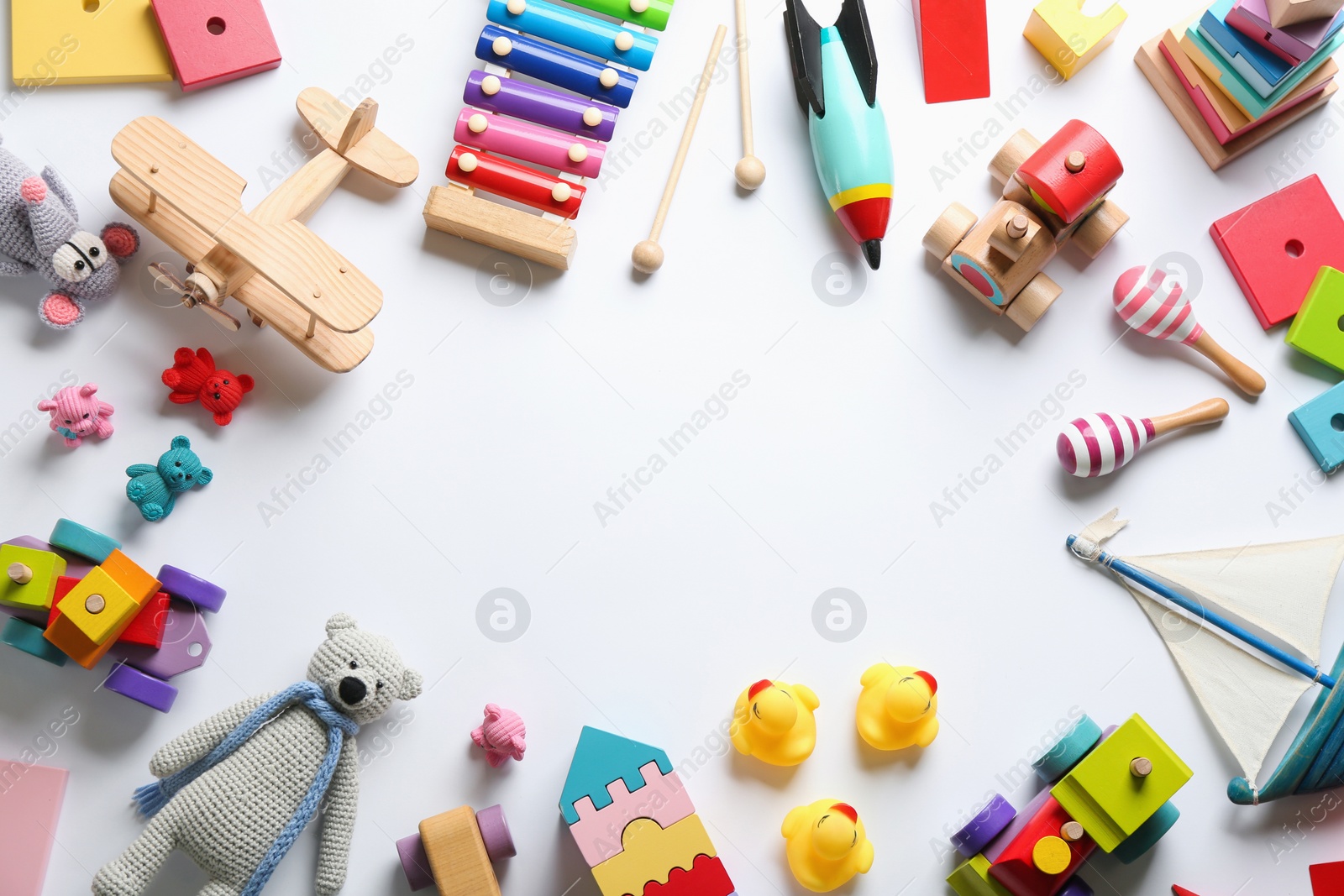 Photo of Frame of different toys on white background, flat lay. Space for text