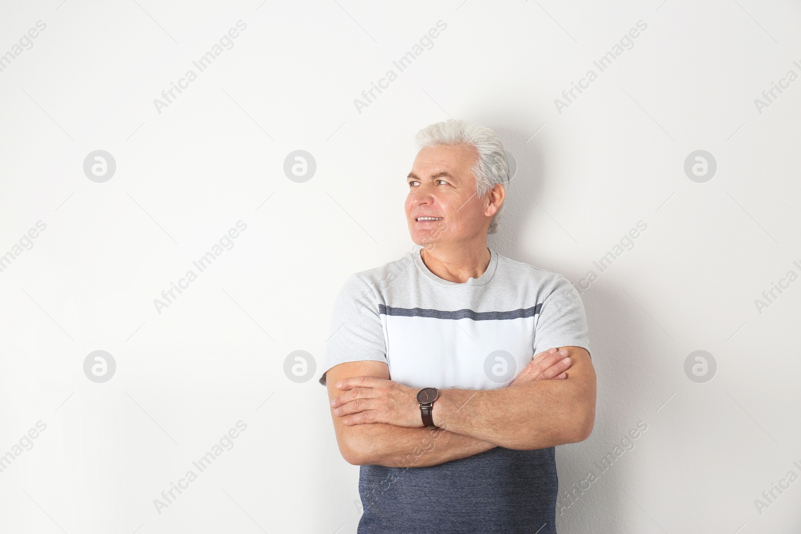 Photo of Portrait of handsome mature man on light background. Space for text