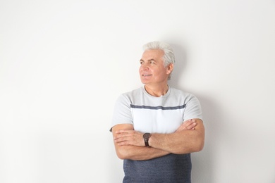 Photo of Portrait of handsome mature man on light background. Space for text