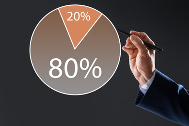 Image of Pareto principle concept. Man drawing chart with 80/20 rule representation on grey background, closeup
