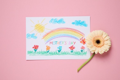 Handmade greeting card for Mother's Day and flower on pink background, flat lay