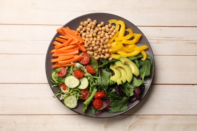 Photo of Balanced diet and vegetarian foods. Plate with different delicious products on wooden table, top view