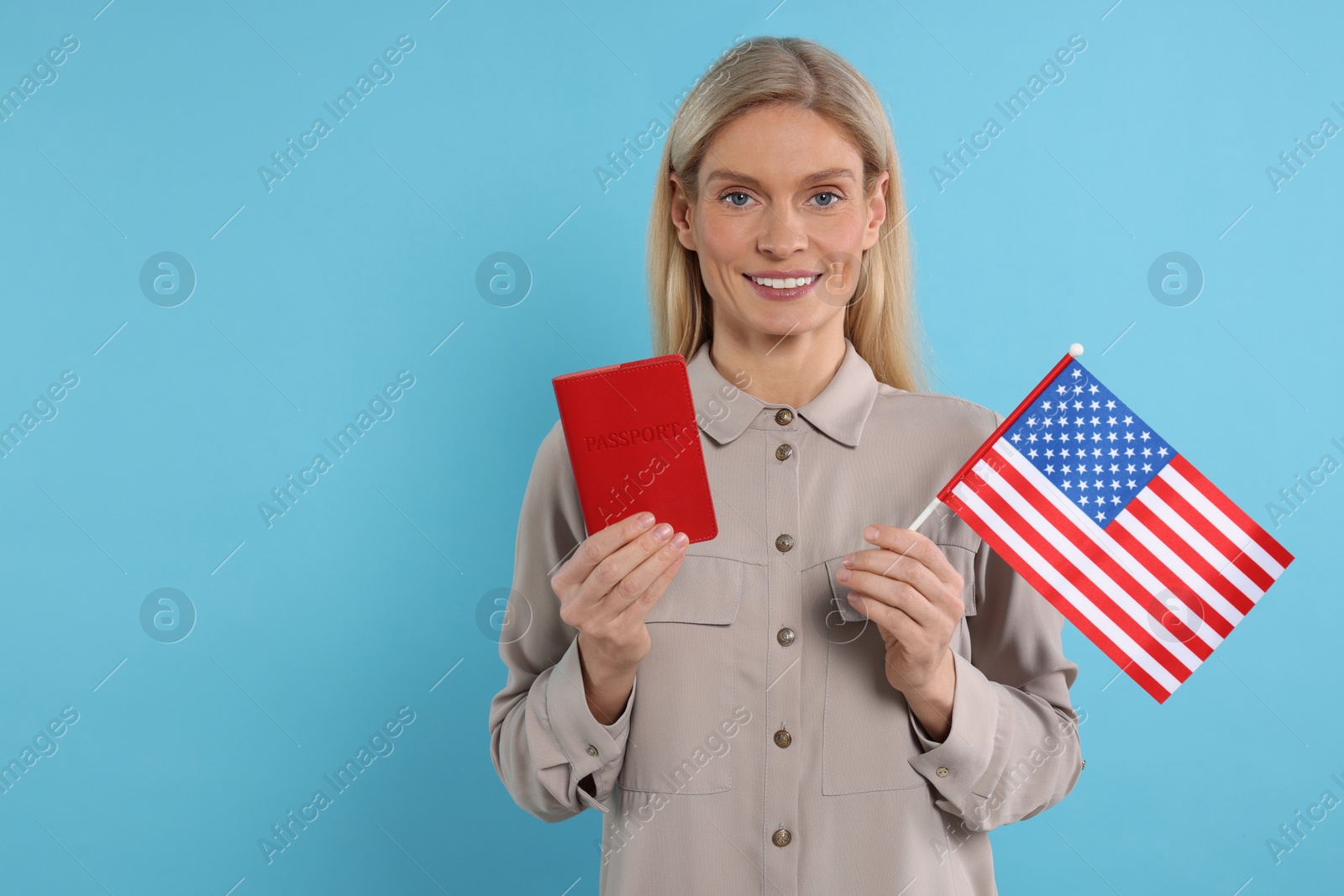 Photo of Immigration. Happy woman with passport and American flag on light blue background, space for text