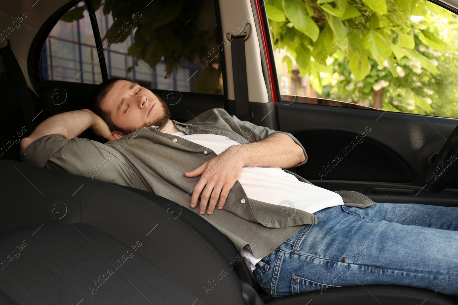 Photo of Tired man sleeping in his modern car